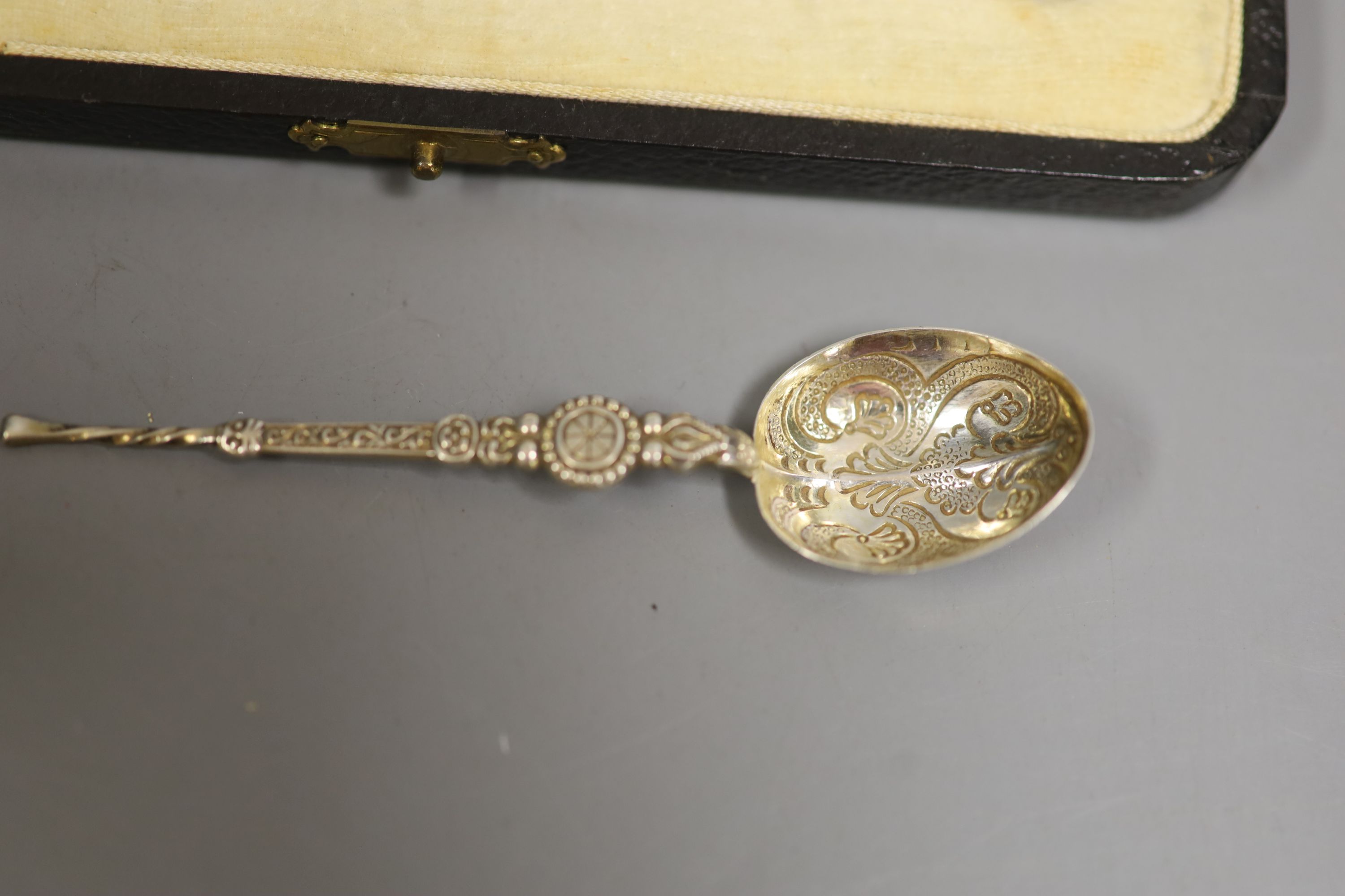 A cased set of six silver and enamel(a.f.) bean end coffee spoons, one other silver spoon, a silver napkin ring and small silver trophy cup.